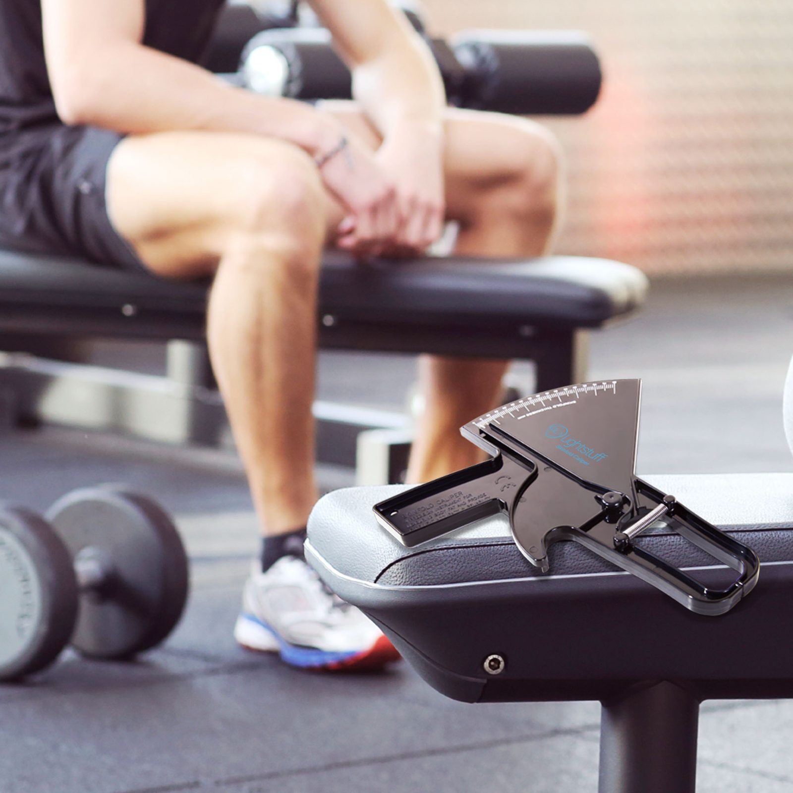Lightstuff Precision Skinfold Caliper on a workout bench in the gym